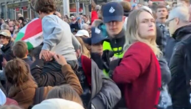 Vrouw met kind die Palestijnse vlag laat zien tijdens dodenherdenking wordt keihard aangepakt door de politie